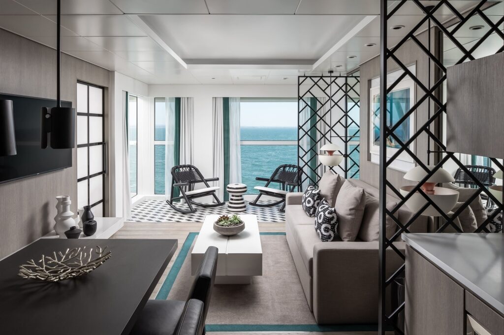 Modern interior of Celebrity Suite with massive windows overlooking the sea