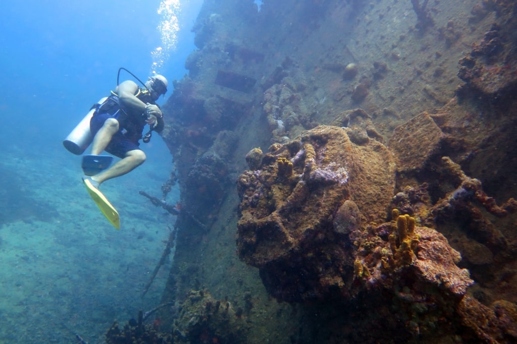 Person scuba diving in SS Antilla