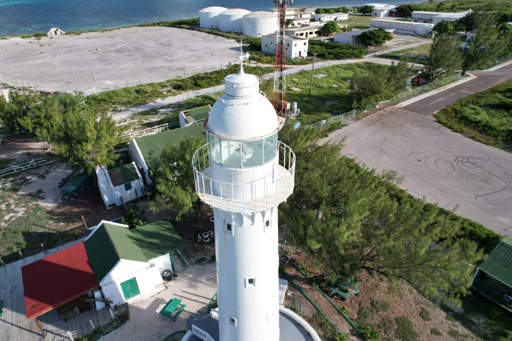 View of the white lighthouse near the beach