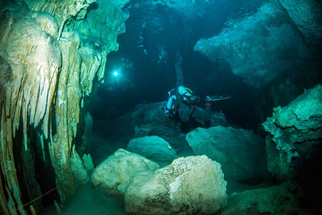 Person scuba diving in Cenote Dos Ojos