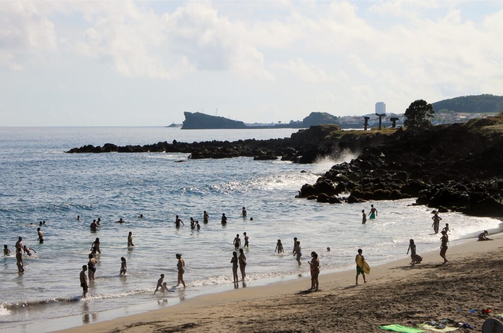 People enjoying the beach of Praia do Pópulo