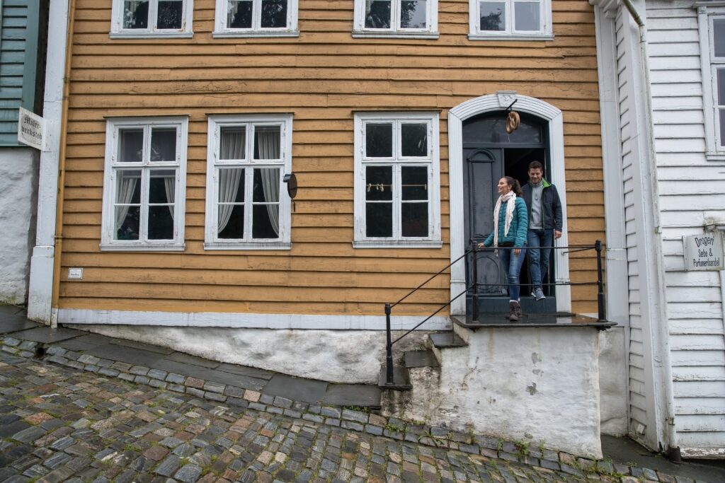 Couple exploring Old Bergen Museum in Bergen Norway