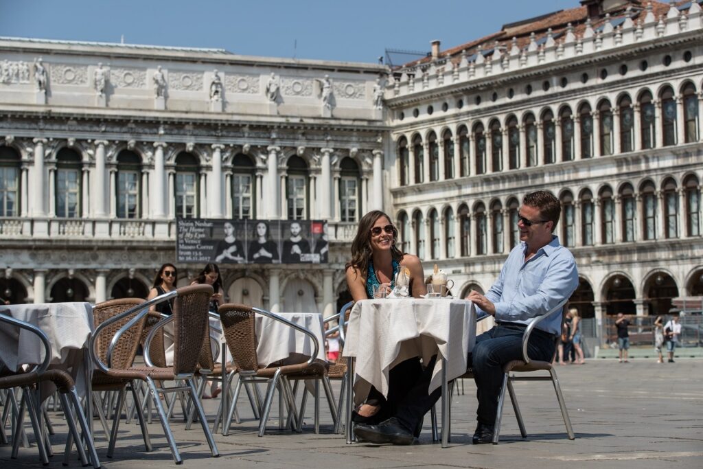 Couple enjoying coffee along St. Mark's Square