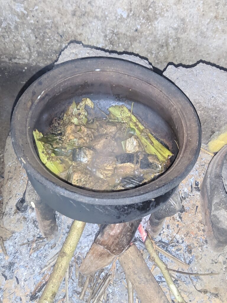 Cooking fish ambul thiyal in a pot
