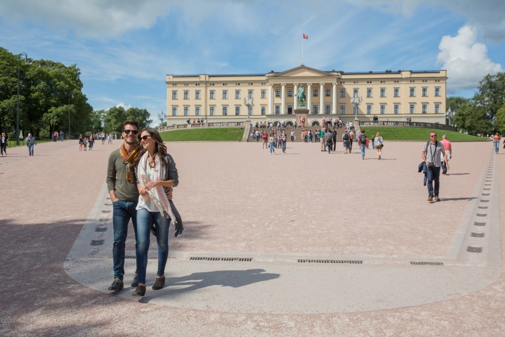 Couple exploring the Royal Palace in Oslo, Norway