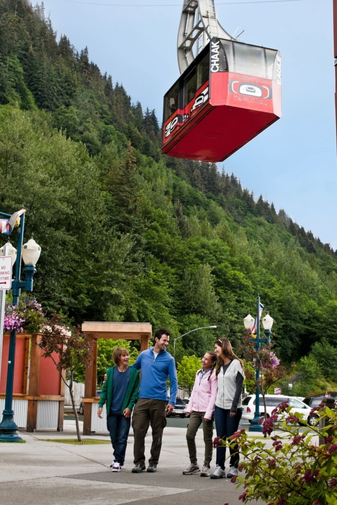 Family exploring Juneau with view of Mount Roberts Tramway