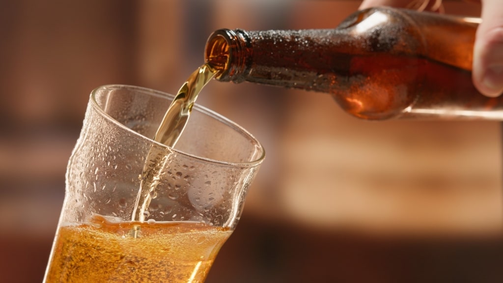 Man pouring beer into a cup