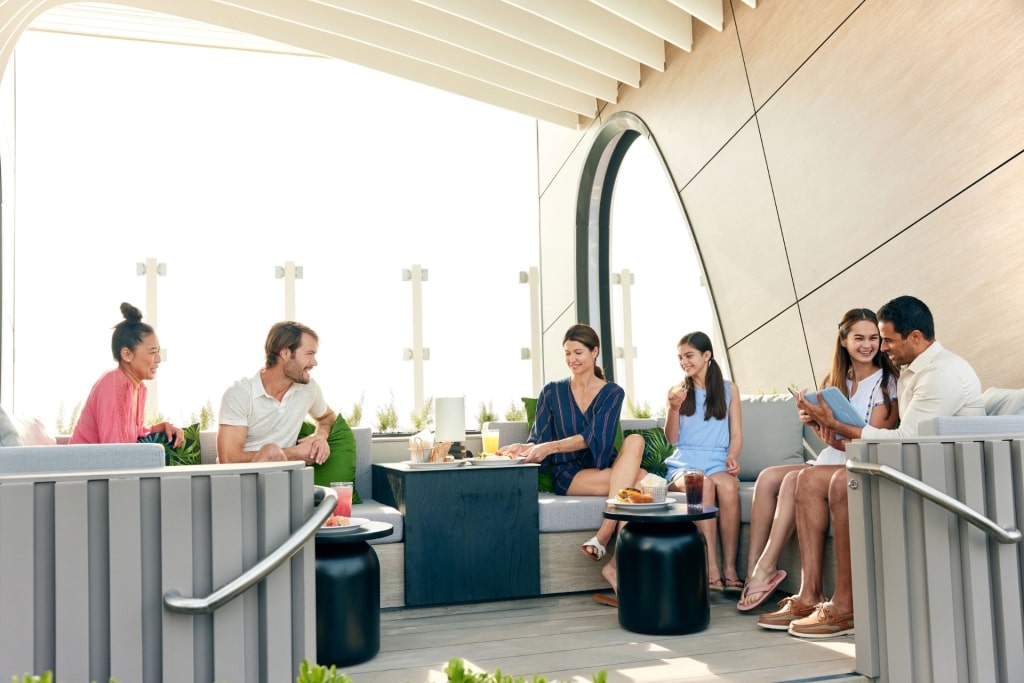 Family relaxing from a cabana aboard Celebrity