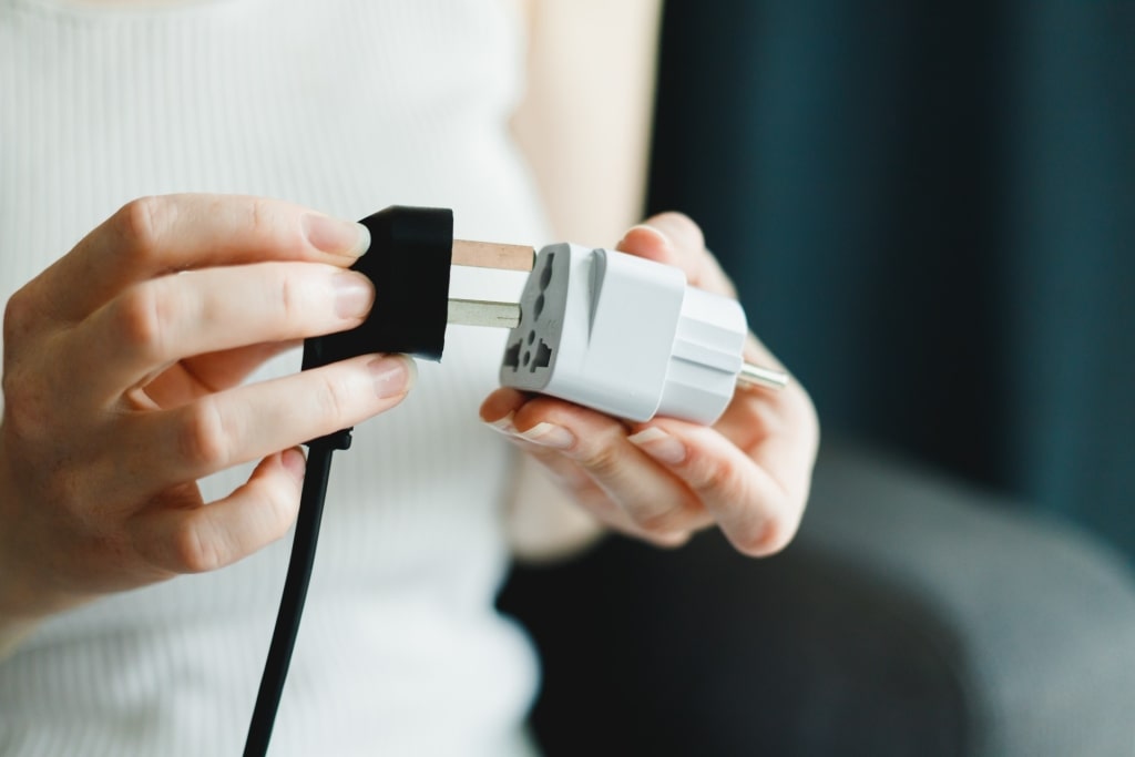 Woman trying the outlet adapter