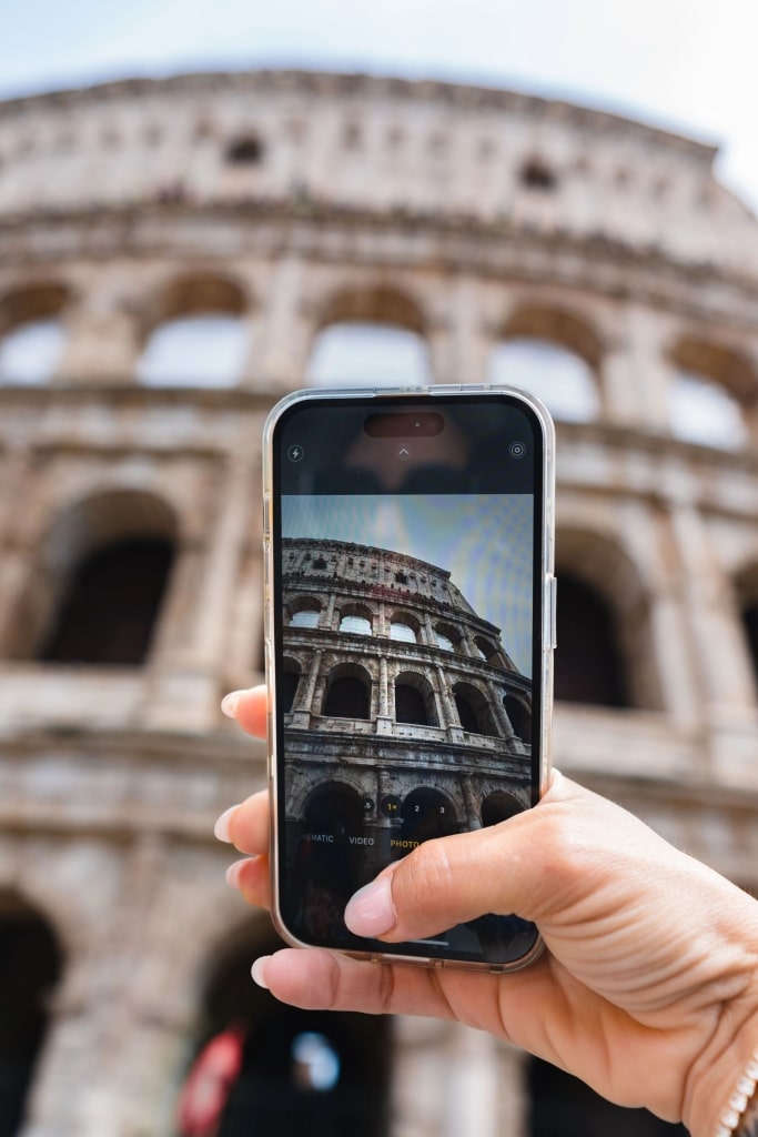 Person taking a photo of Colosseum, Rome