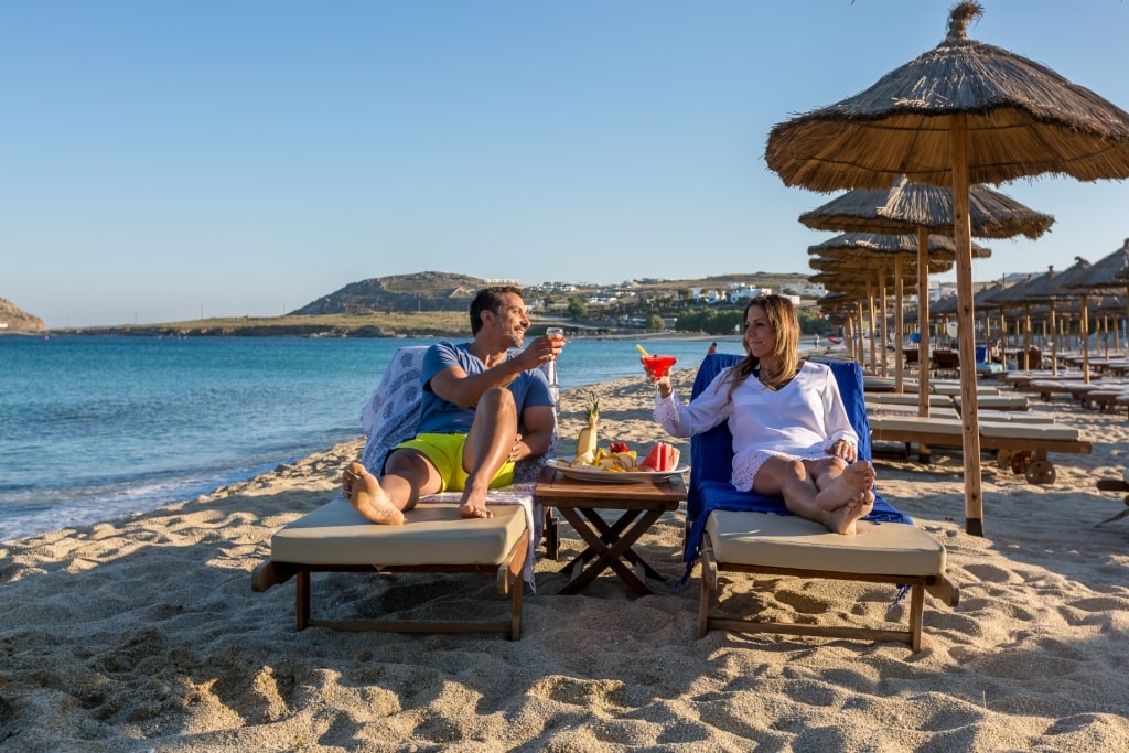 Couple relaxing on Kalafatis Beach in Mykonos