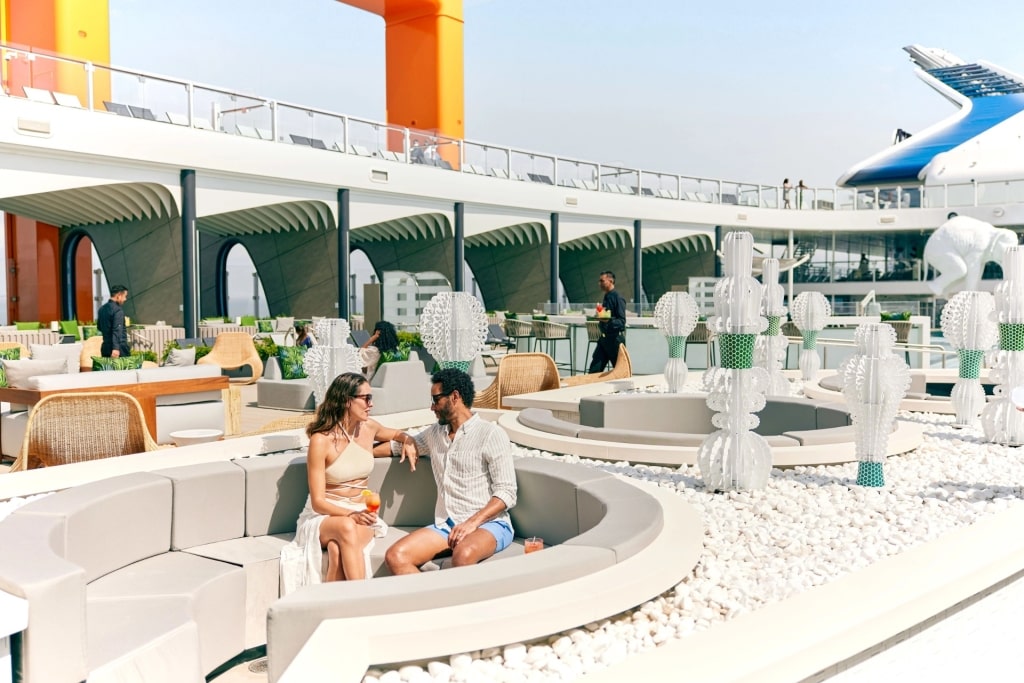 Couple relaxing on the lido deck aboard Celebrity