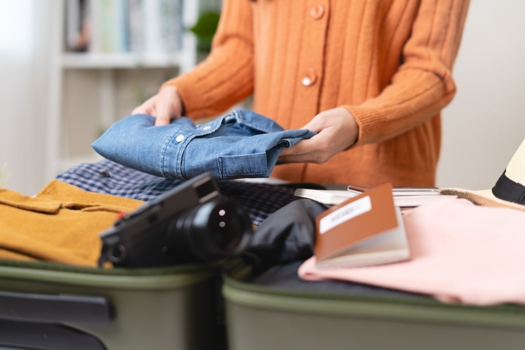 Woman packing a carry-on luggage