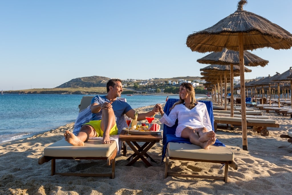 Couple relaxing on Kalafatis Beach, Mykonos