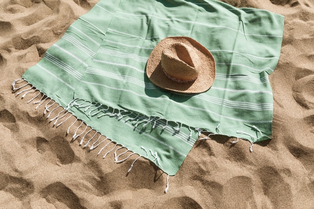 Light green beach towel on the beach