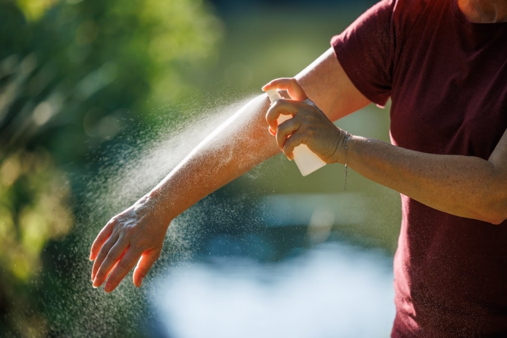 Man using bug repellent