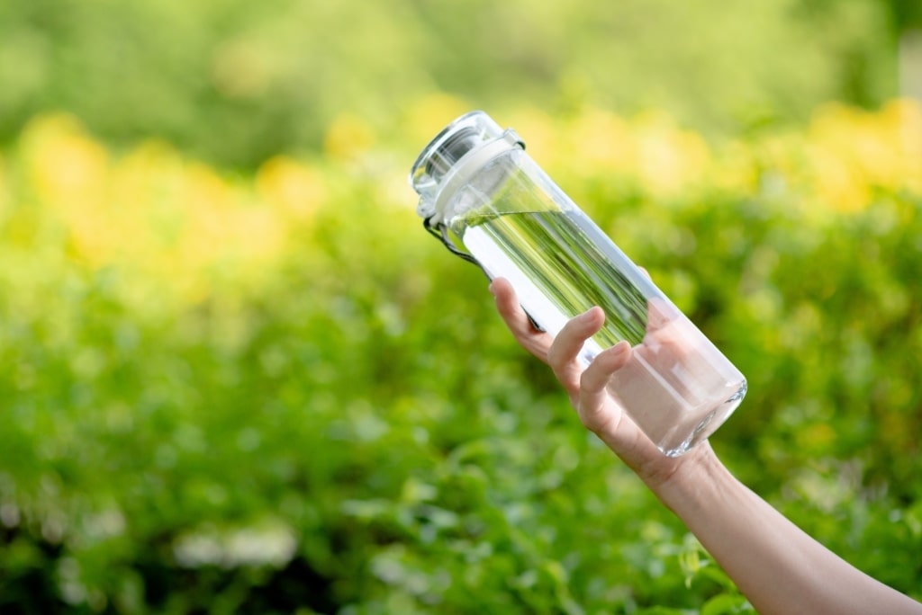 Person holding a refillable bottle