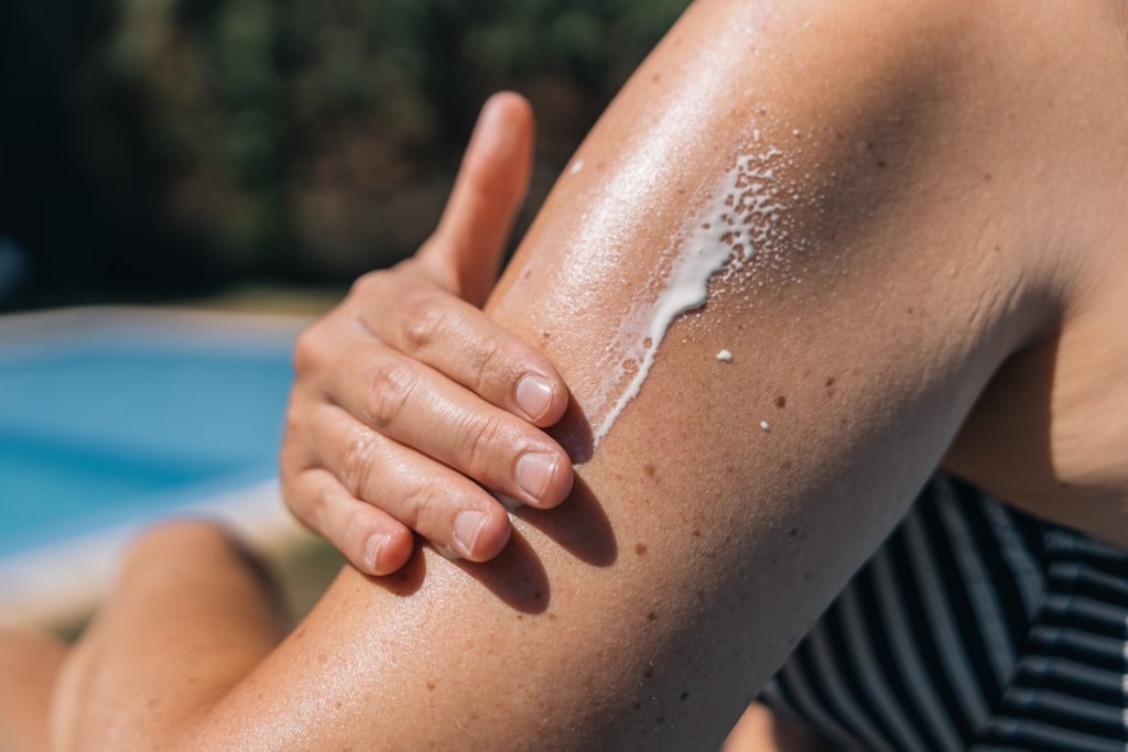 Woman applying sunscreen