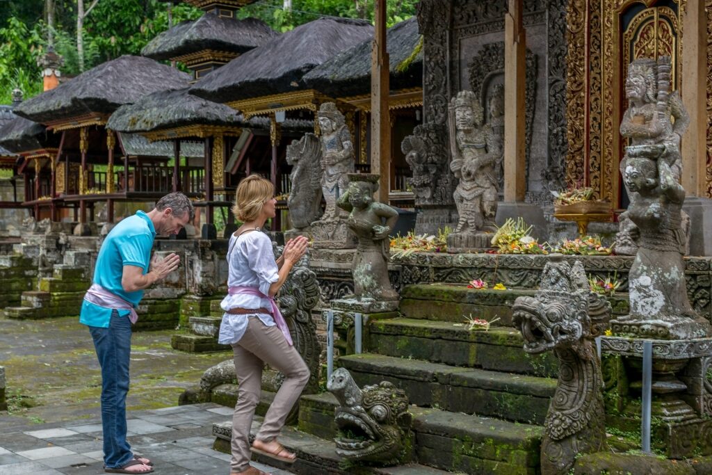 Couple paying respects at a temple in Bali