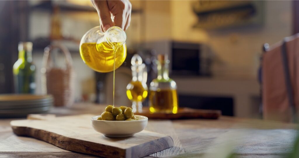 Pouring olive oil into a cup