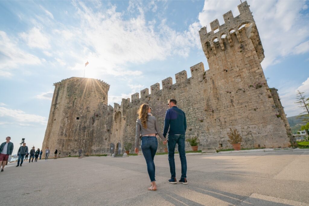 Couple walking to Kamerlengo Castle, Trogir