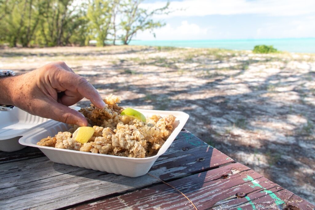 Man eating conch at the beach