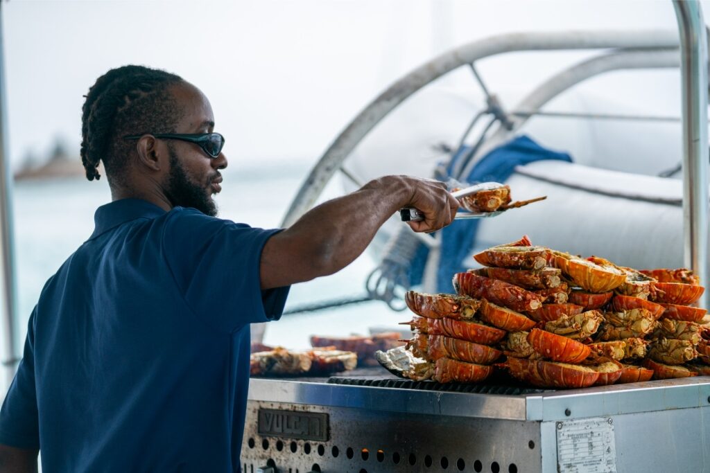 Man grilling lobster in the Caribbean